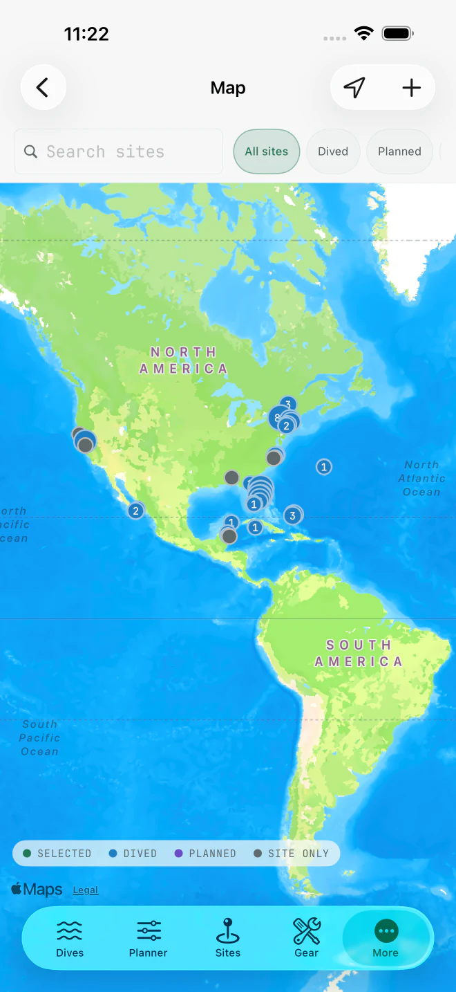 Map on iPhone showing dived, planned, and saved dive sites across the Americas